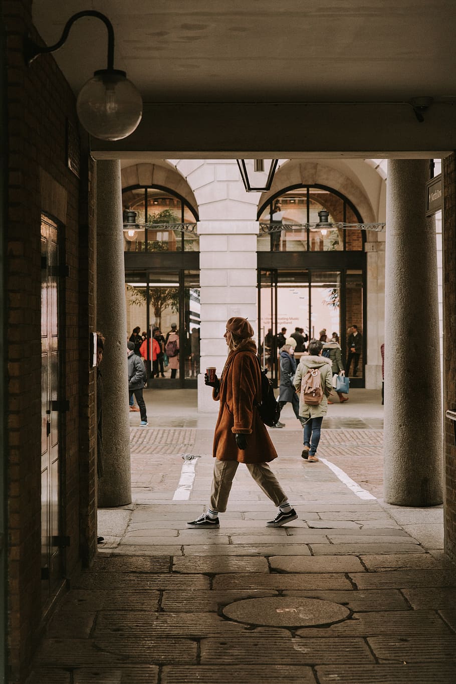 Woman Walking Through Building, architecture, city, daylight HD wallpaper