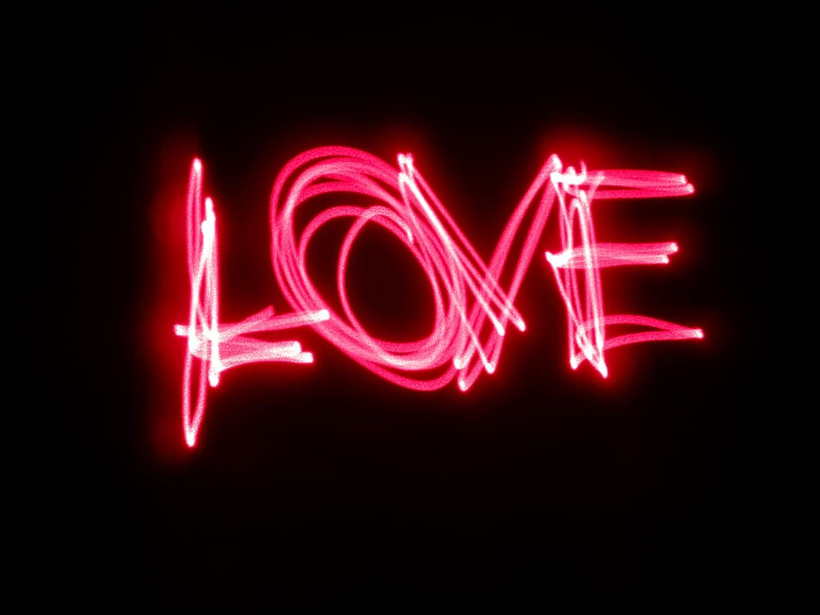A pink neon light painting that says 