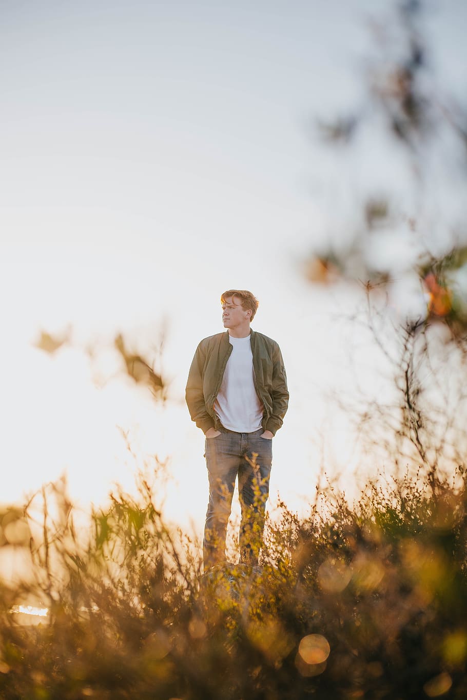 man standing on brown grass, male, sunset, sunrise, outdoors HD wallpaper