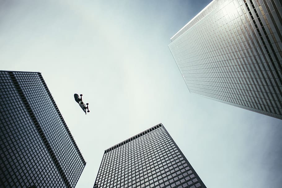 Pesrpective view of skateboard in the air with skyscrapers, architecture, HD wallpaper