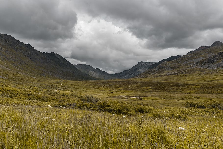 grass field between mountains on cloudy day, nature, outdoors HD wallpaper