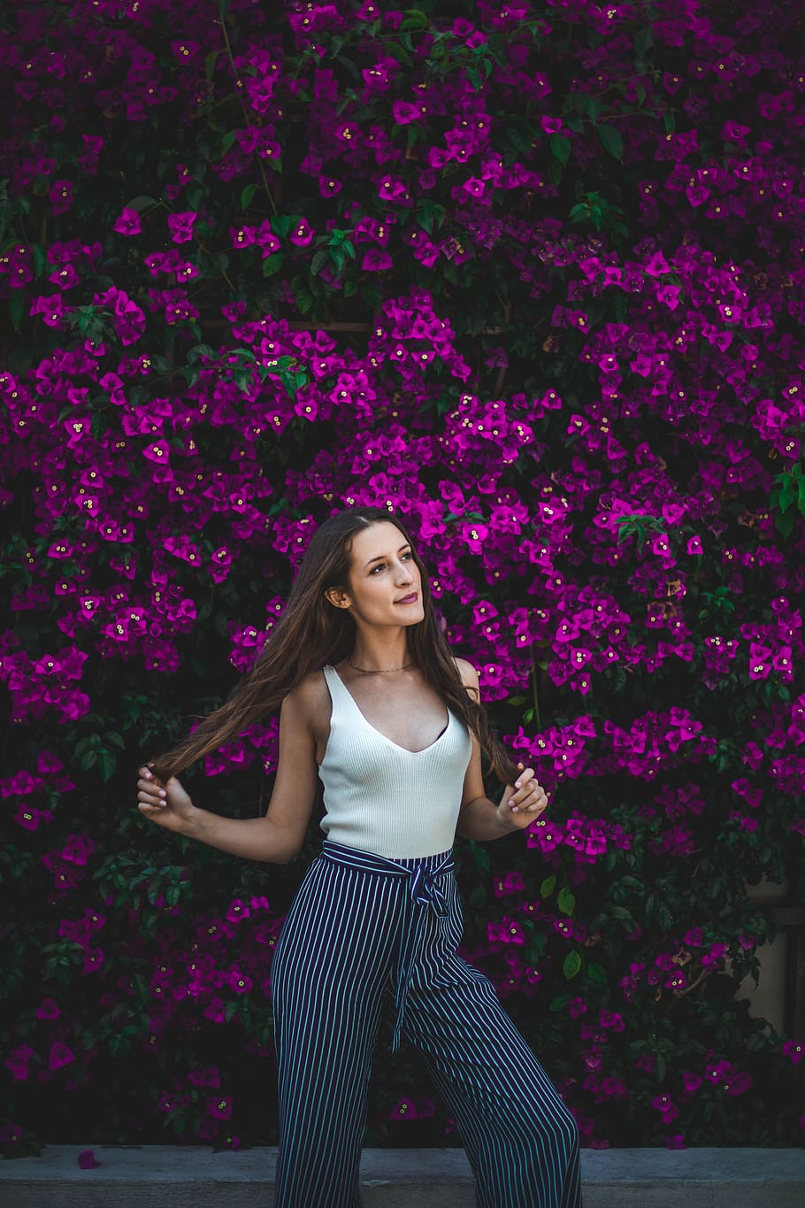 smiling woman holding her hair in front of purple flowers during daytime, HD wallpaper