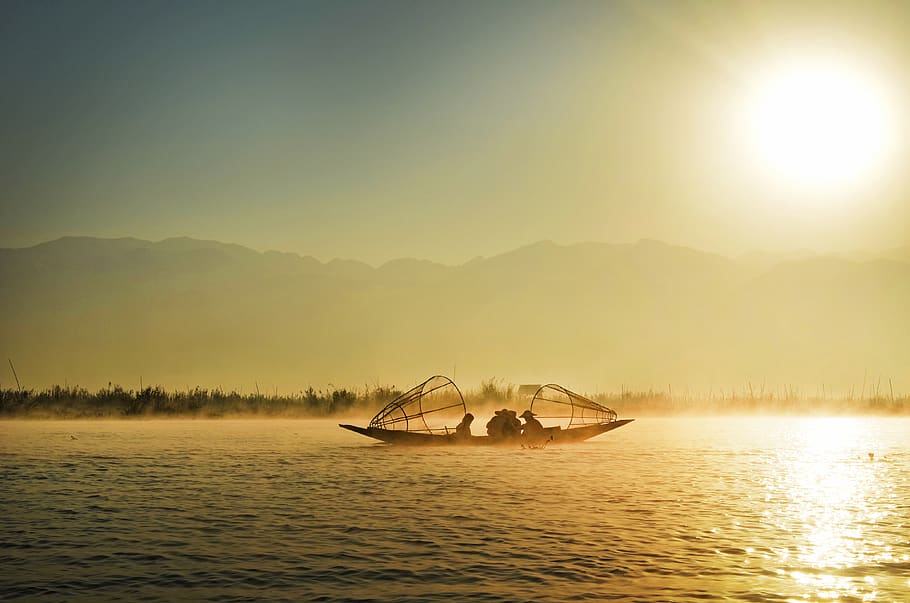 Group of People Riding Boat in the Middle of Water during Sunrise HD wallpaper