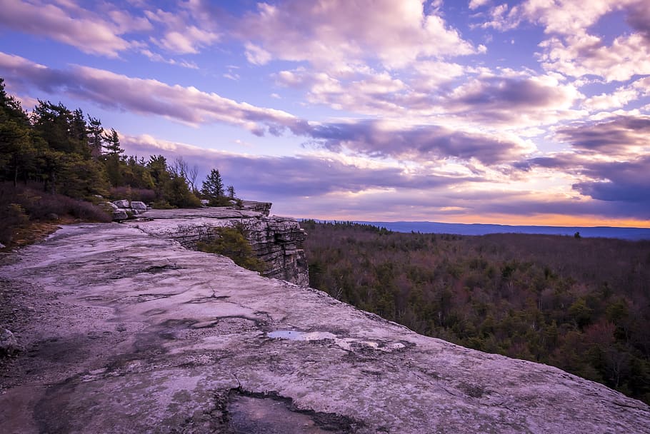 grey mountain with trees under dramatic clouds during daytime HD wallpaper