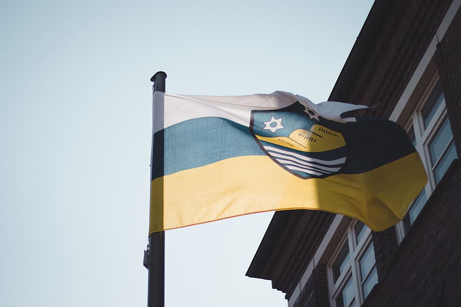 white, blue, and yellow striped flagpole near building, emblem, HD wallpaper