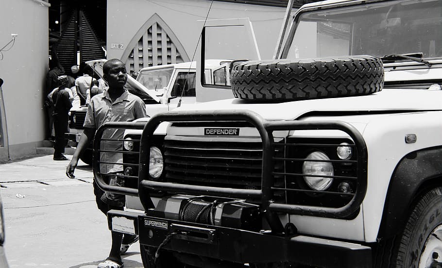 person-watching-land-rover-defender-in-g