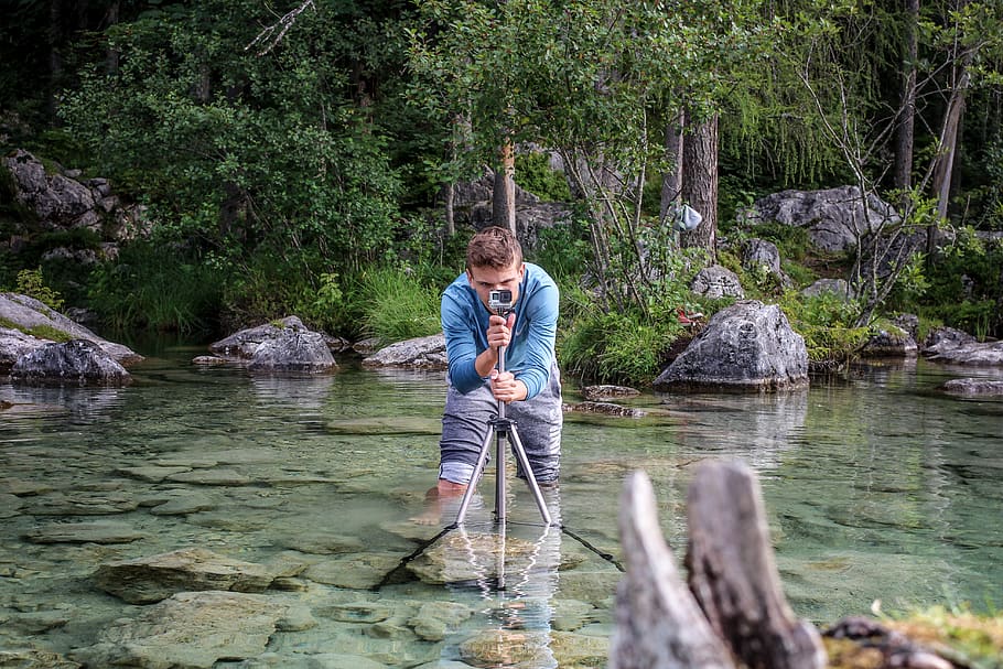 man taking a photo while standing on river, water, tree, plant HD wallpaper