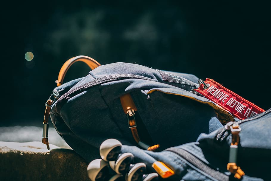 blue backpack on concrete floor, no people, focus on foreground HD wallpaper