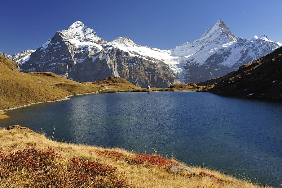 Body of Water With Snow-covered Mountain Range in Background HD wallpaper