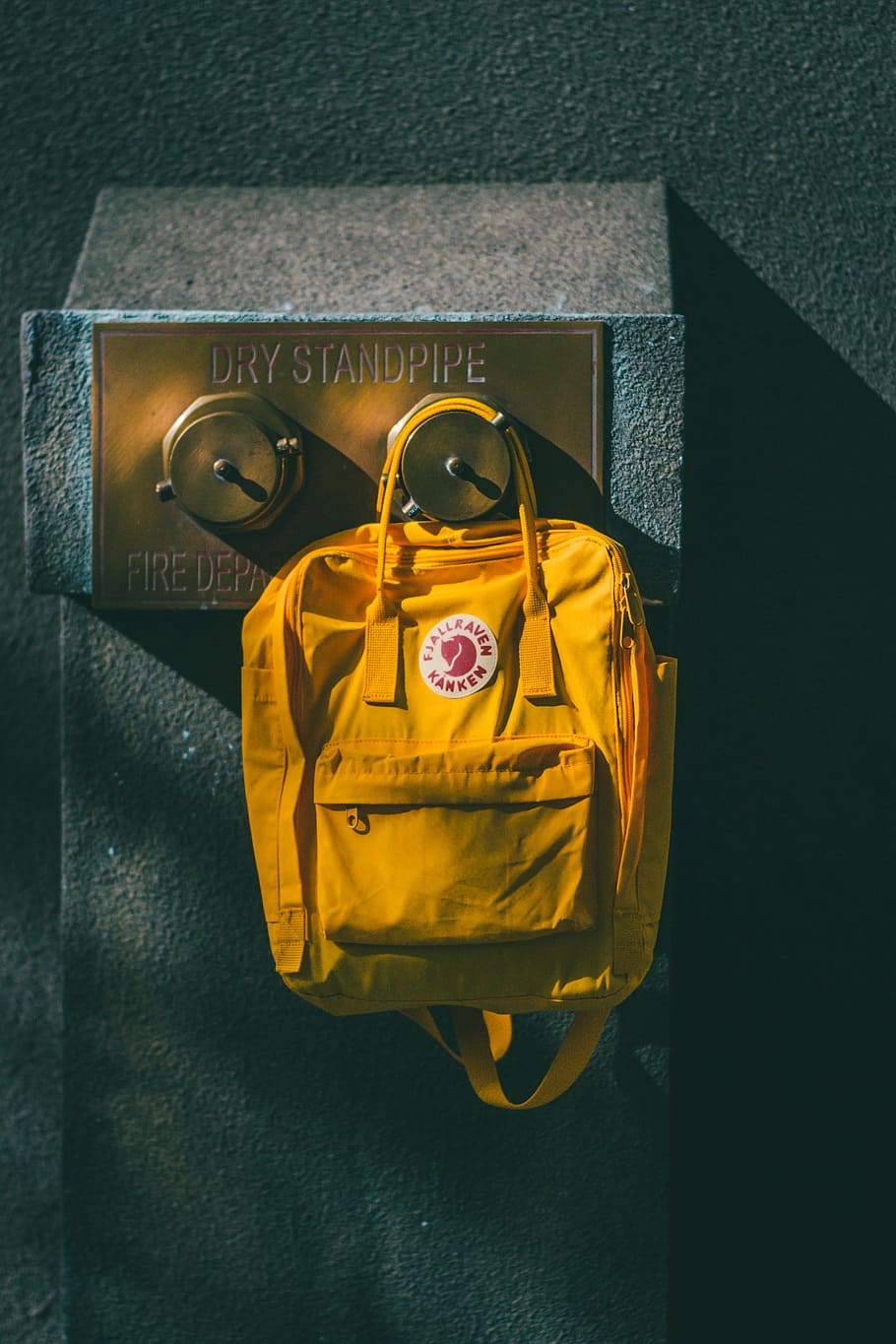 yellow backpack hanging on brown wall leg shelf, bag, accessory