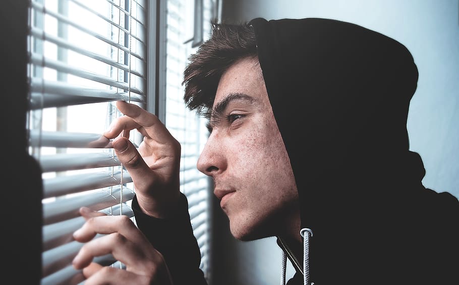 man holding white window blinds while looking outside, hoodie HD wallpaper