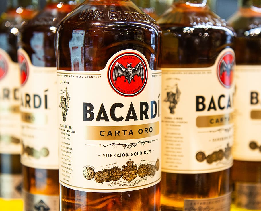 Bacardi Carta Oro superior gold rum bottles, text, container