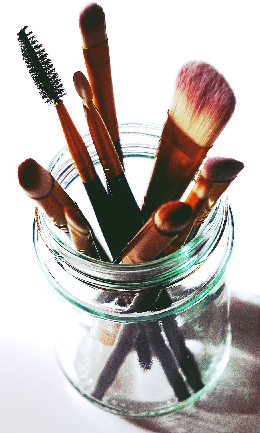 Brown Makeup Brushes in Clear Glass Mason Jar, bottle, close-up