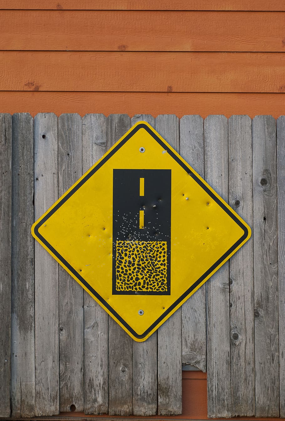 Yellow and Black Road Sign on Gray Wooden Fence, alert, attention
