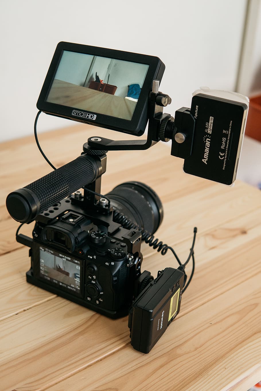 turned-on DSLR camera and displaying table top, electronics, video camera