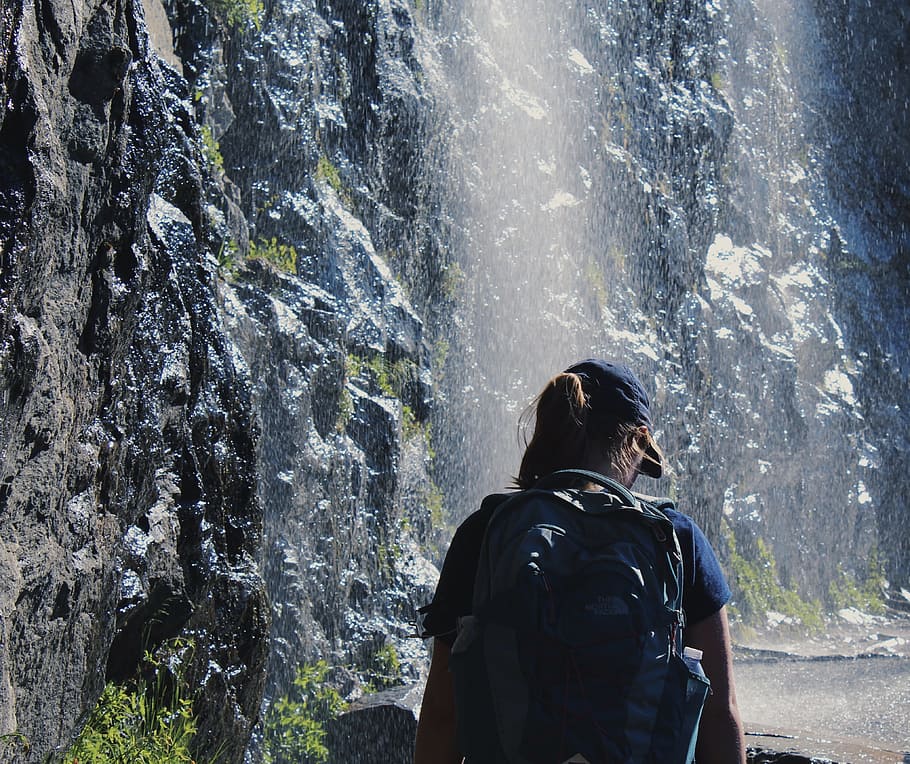 Person Walking Under Waterfalls, backpack, daylight, daytime HD wallpaper