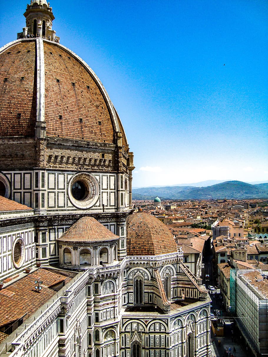 Brown and White Painted Cathedral Roof Overlooking City and Mountain Under Blue Sky HD wallpaper