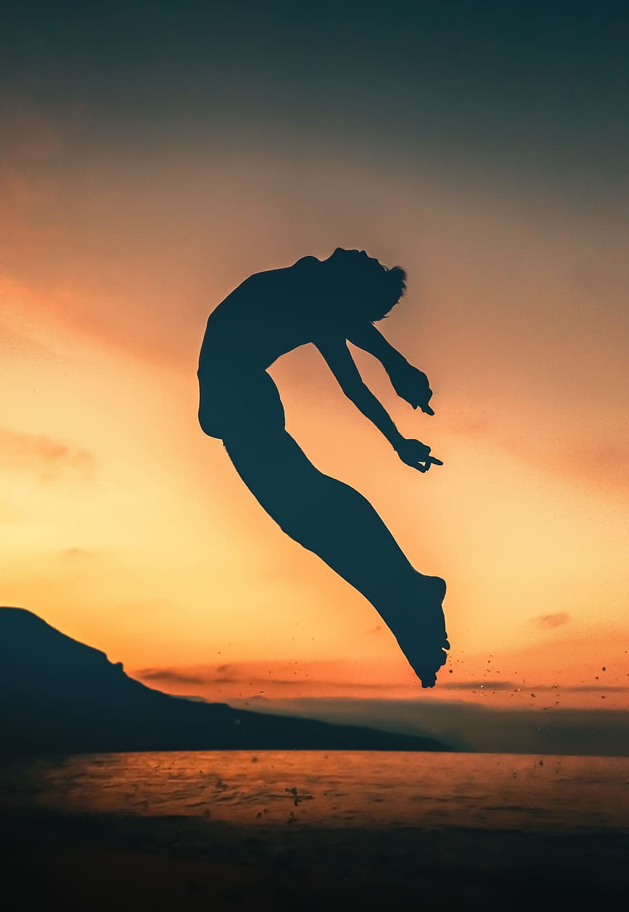 silhouette of person jumping on seashore, sky, sunset, sunrise