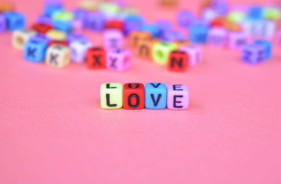 HD wallpaper: Selective Focus Photo of Green, Red, Blue, and Pink Love Bead on Pink Surface - Wallpaper Flare