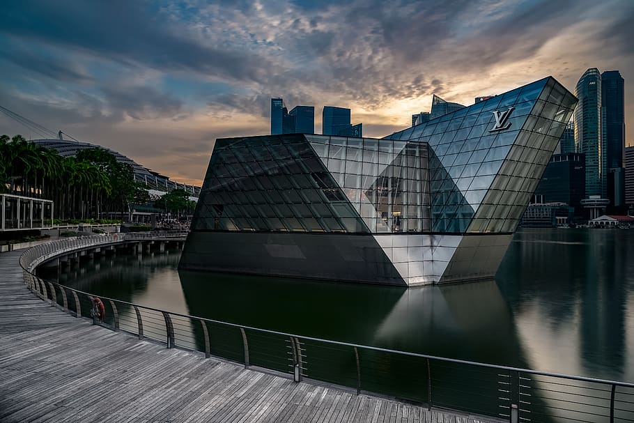 Louis Vuitton building surrounded by body of water, architecture