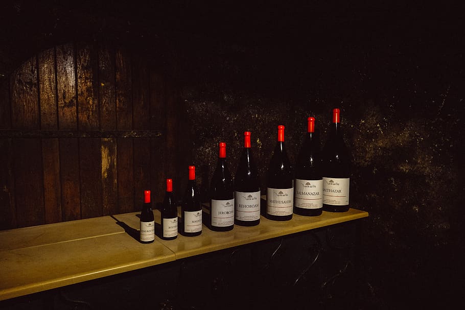 assorted wine bottles on table, wood - material, in a row, arrangement HD wallpaper