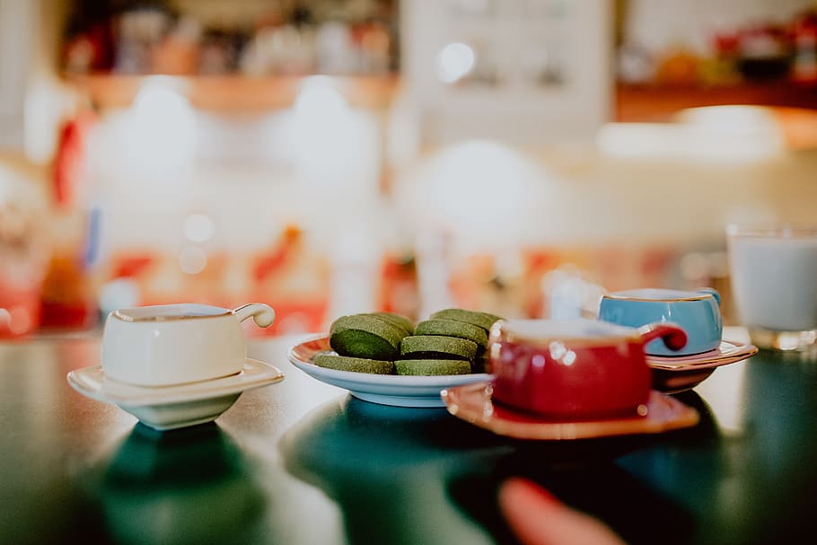 Any cups on the table. Green Beans and Tea on the Table. Red food Table. Tea on Table in back Yard.