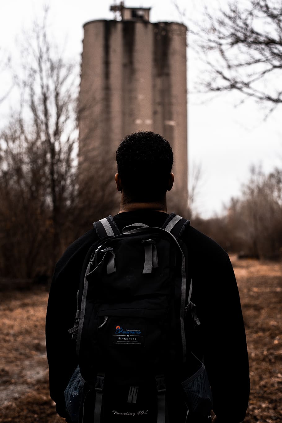 man facing gray building, bag, backpack, person, human, architecture HD wallpaper