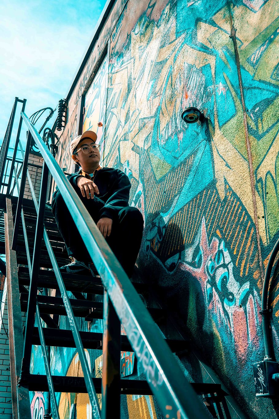 Man Sitting On Black Stairs, architecture, graffiti, person, staircase HD wallpaper