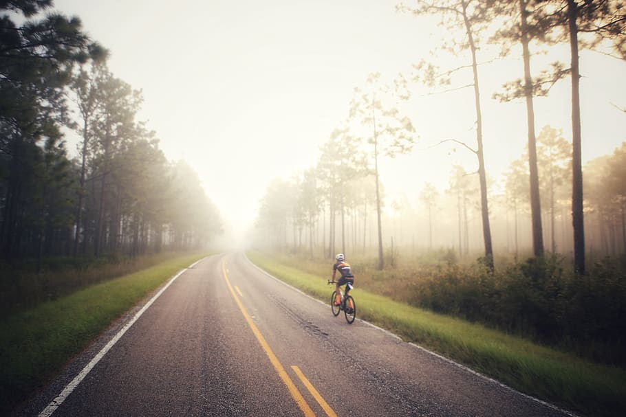 man riding bicycle on highway, road, dirt road, gravel, weather HD wallpaper