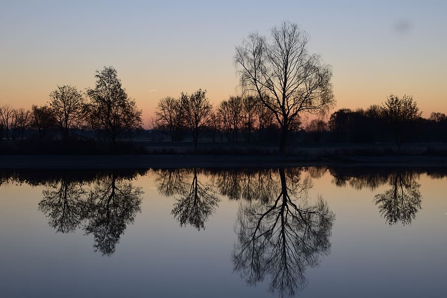 Reflection of Silhouette Trees in Lake Against Sky at Sunset HD wallpaper
