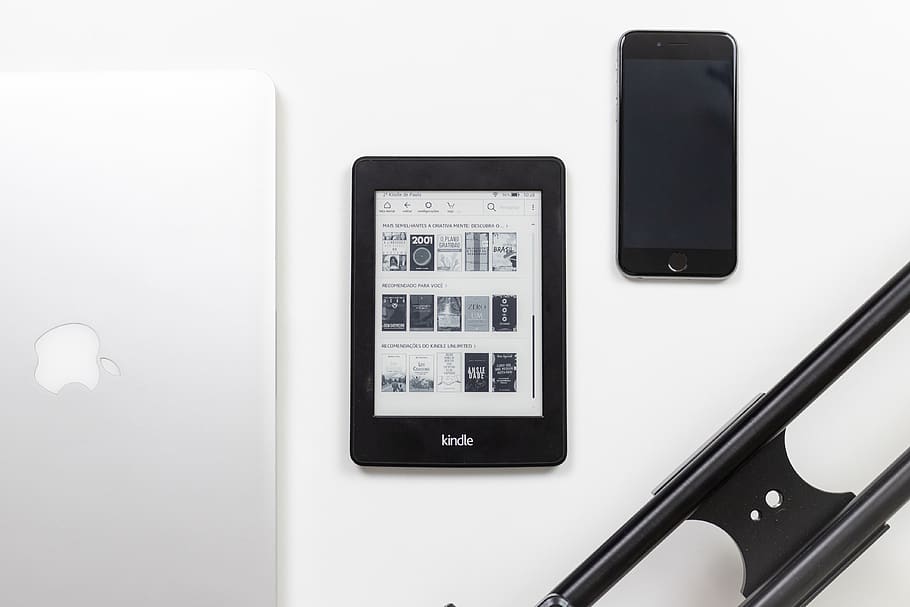 black Amazon Kindle e-book reader on white surface, technology HD wallpaper