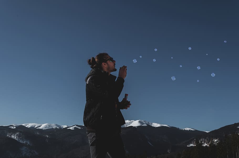 man playing with bubbles, outdoors, nature, human, person, mountain