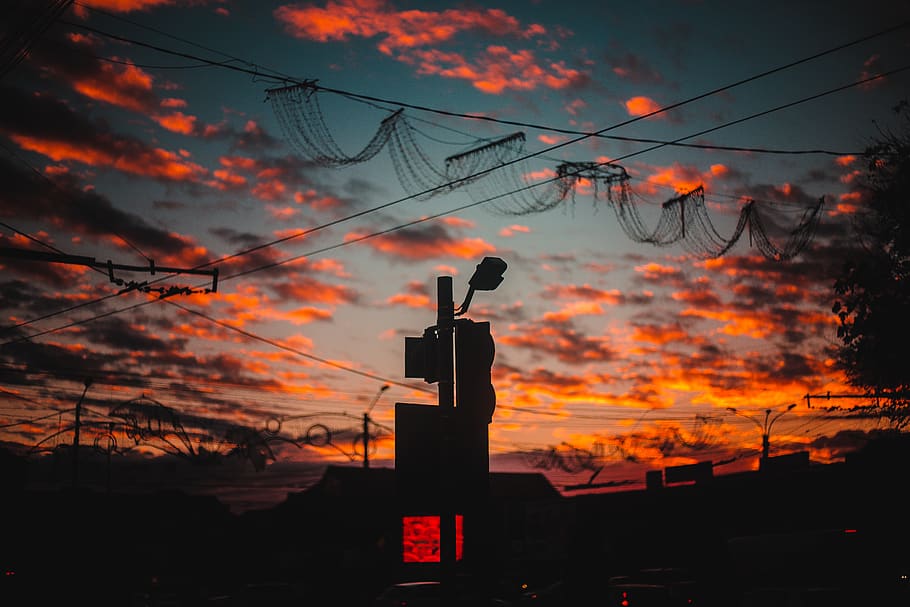 silhouette of building, cable, power lines, utility pole, electric transmission tower