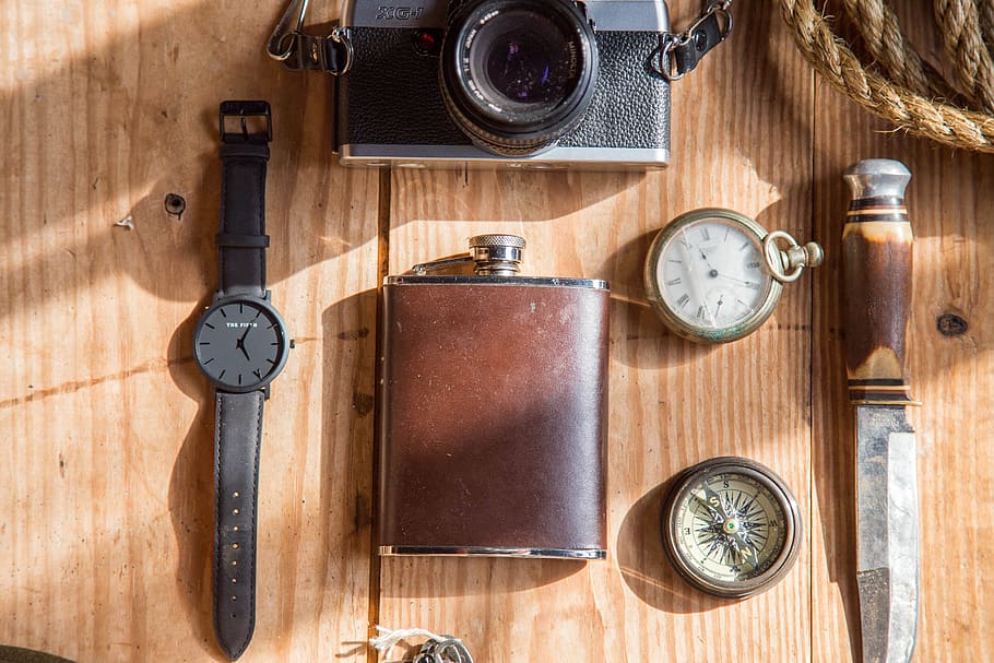 Brown Wine Flask Near Lomo Camera Watch Knife and Pocket Watches on Able HD wallpaper