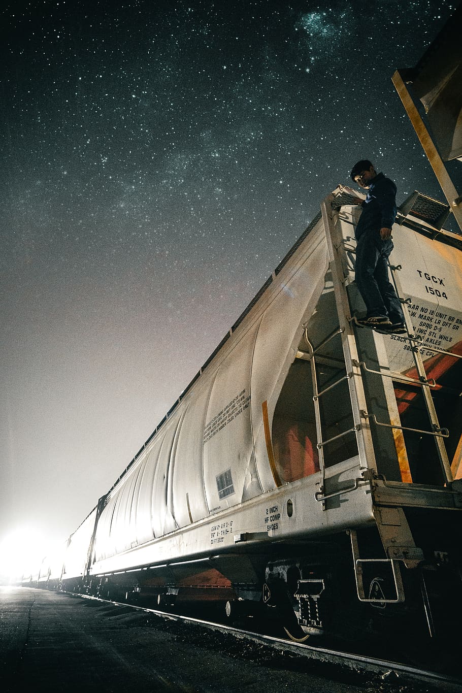 A train under a night sky., person, canada, streetsville, abandoned HD wallpaper