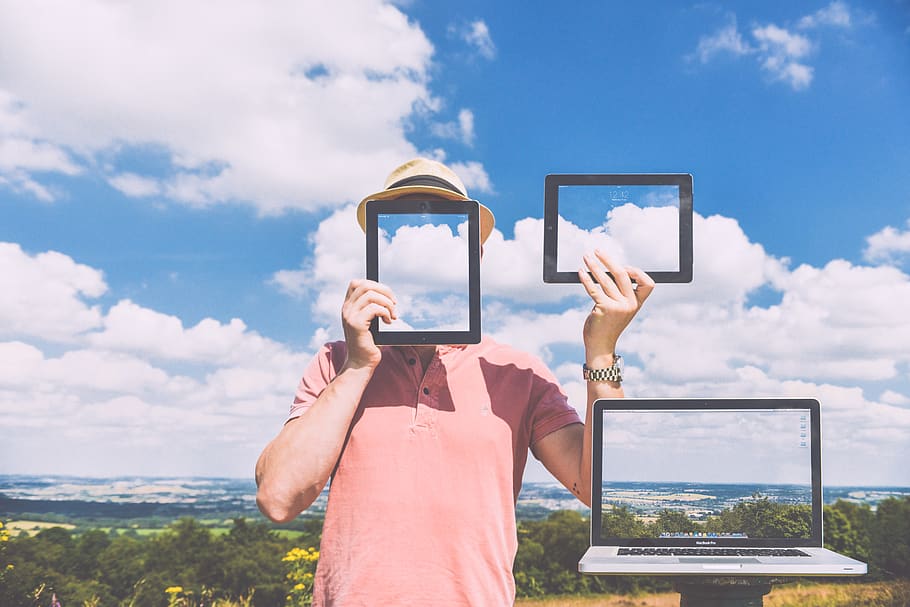 Standing Man Holding Ipads Near Macbook Pro, anonymous, devices HD wallpaper