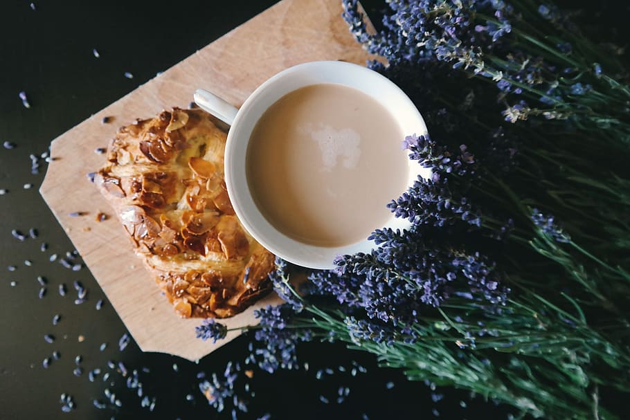 White Ceramic Mug With Brown Liquid Inside Beside Purple Flower and Pastry HD wallpaper