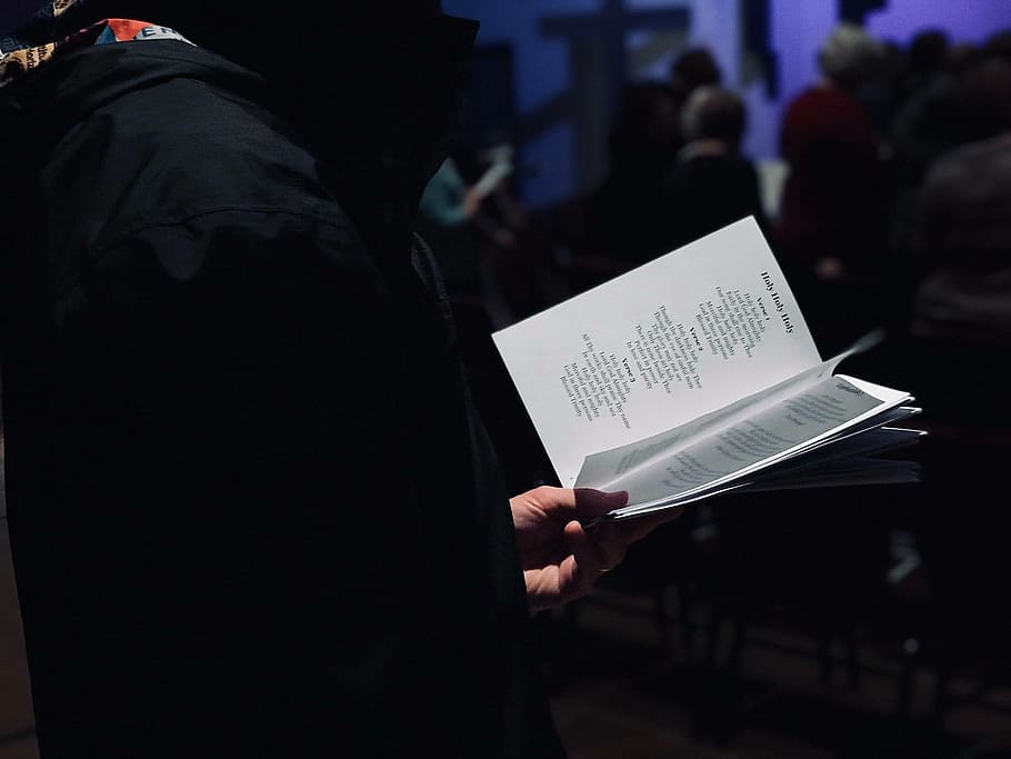 person standing while reading ook, holding, real people, communication HD wallpaper