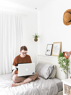 man using white MacBook, bedroom, indoors, human, person, furniture HD wallpaper