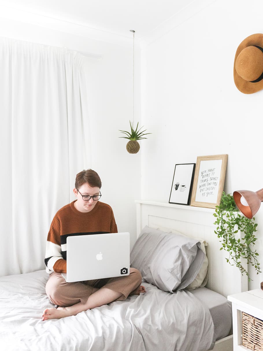 man using white MacBook, bedroom, indoors, human, person, furniture HD wallpaper