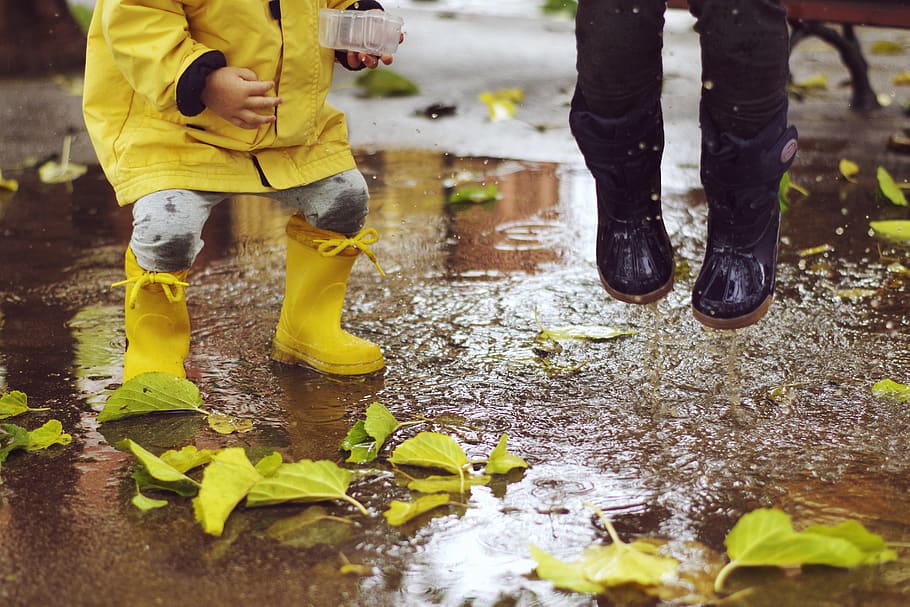 toddler wearing rainboots, low section, water, human leg, wet