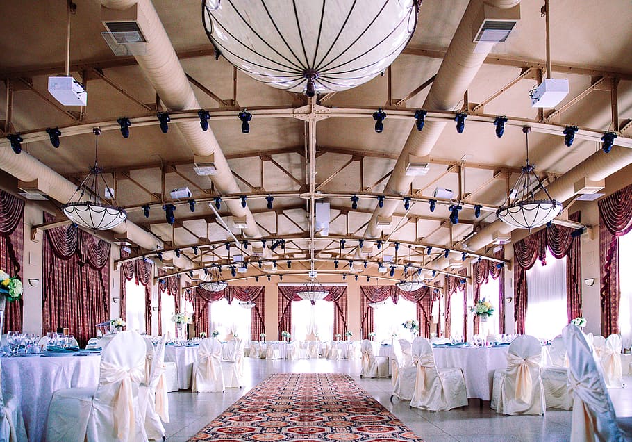 An elegant wedding hall with well arranged tables and chairs