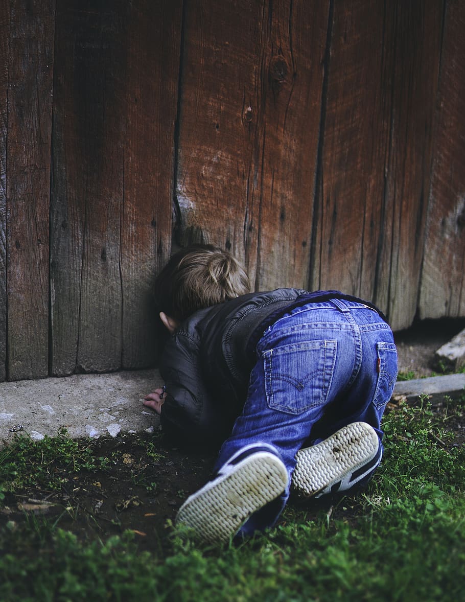 Photo of Boy Peeking on Brown Wooden Fence, child, denim jeans
