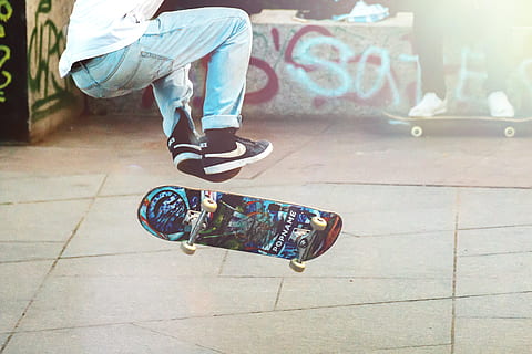 Skateboarder doing a trick in a skate park, one person, low section HD wallpaper