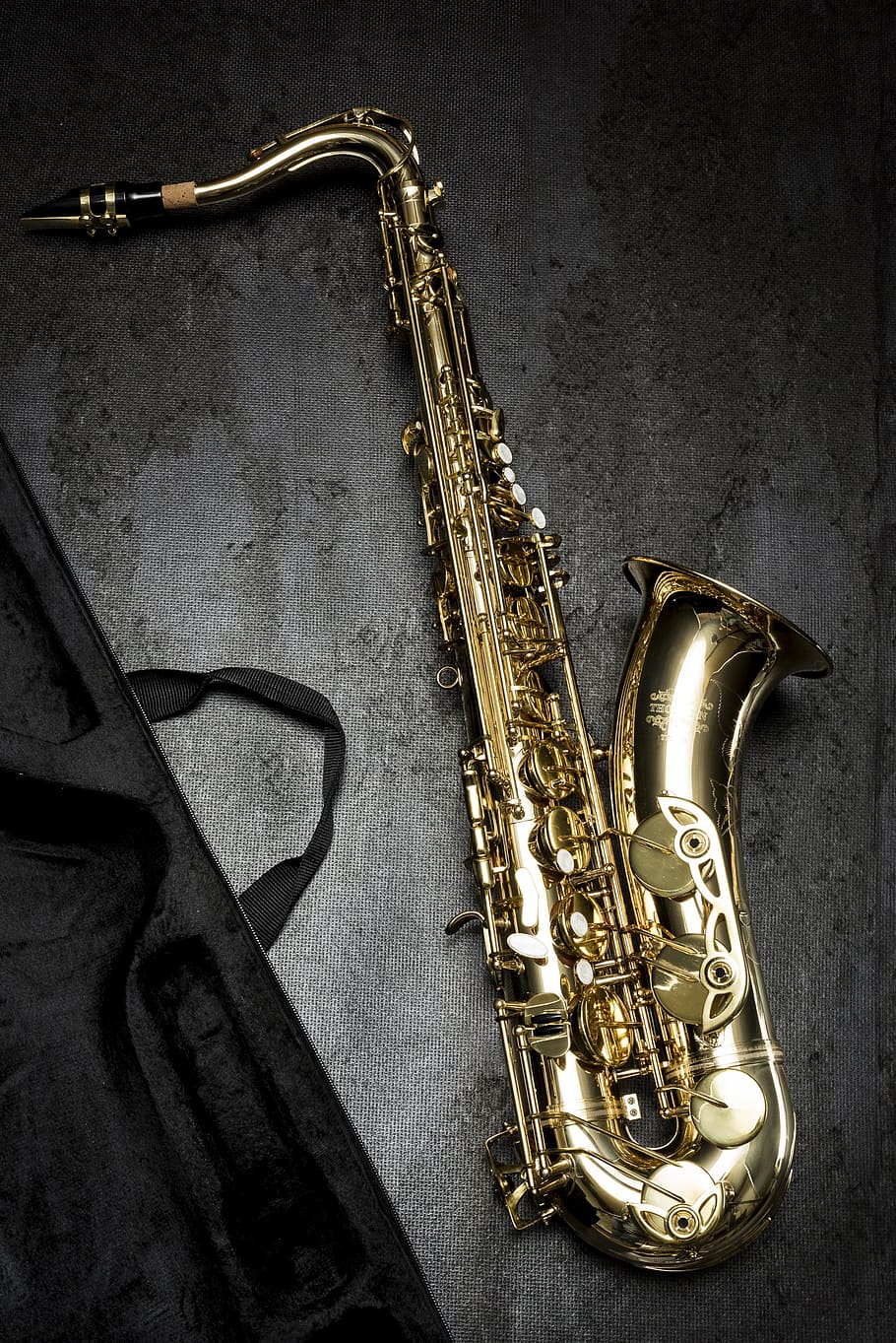 Brass Saxophone on Gray Table Near Black Bag, jazz, musical instrument