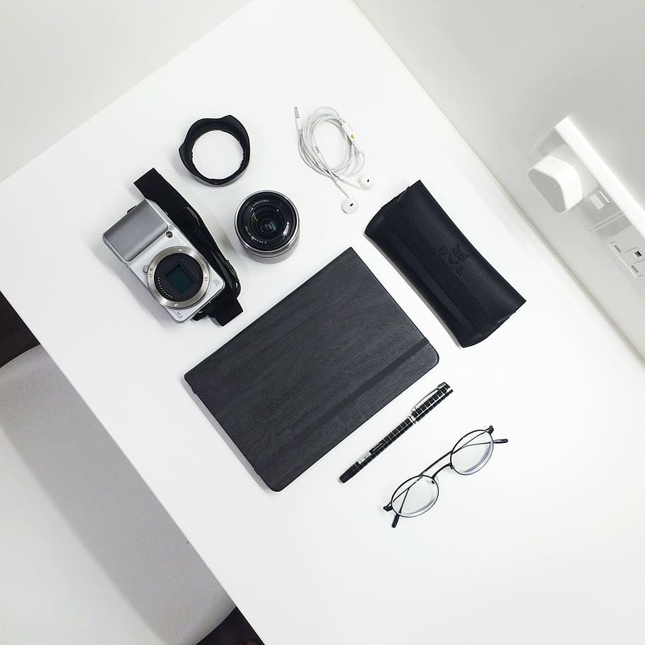 gray and black camera beside tablet computer on white table, high angle view HD wallpaper