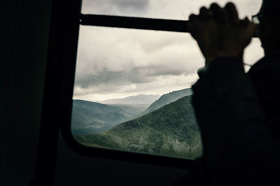 Silhouette Photo of Man Beside Window, backlit, cable car, clouds HD wallpaper