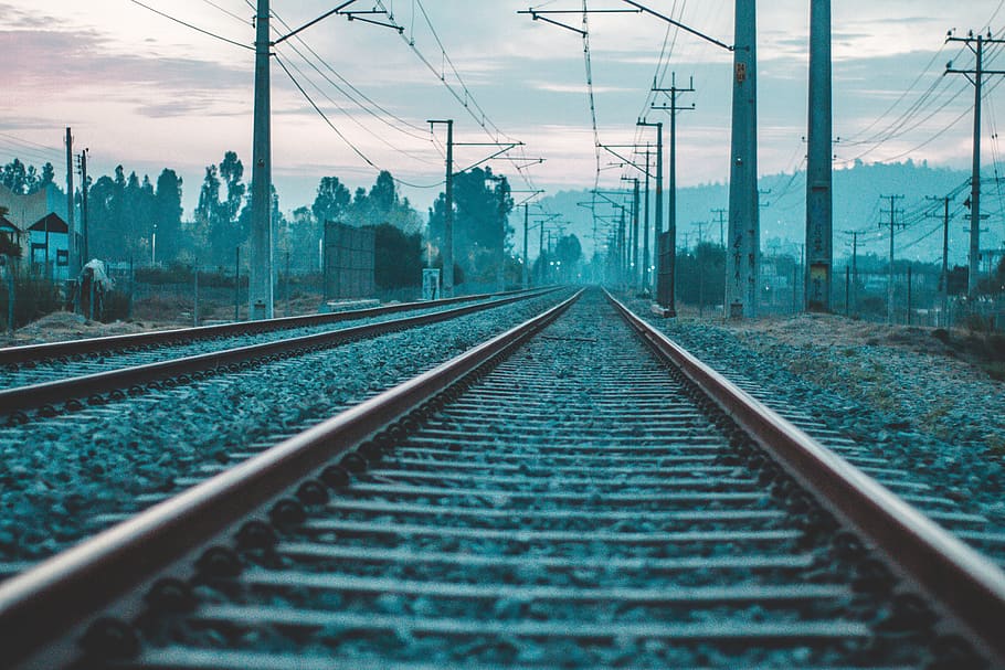 HD wallpaper: gray electricity post lined near brown metal train rail  during daytime | Wallpaper Flare