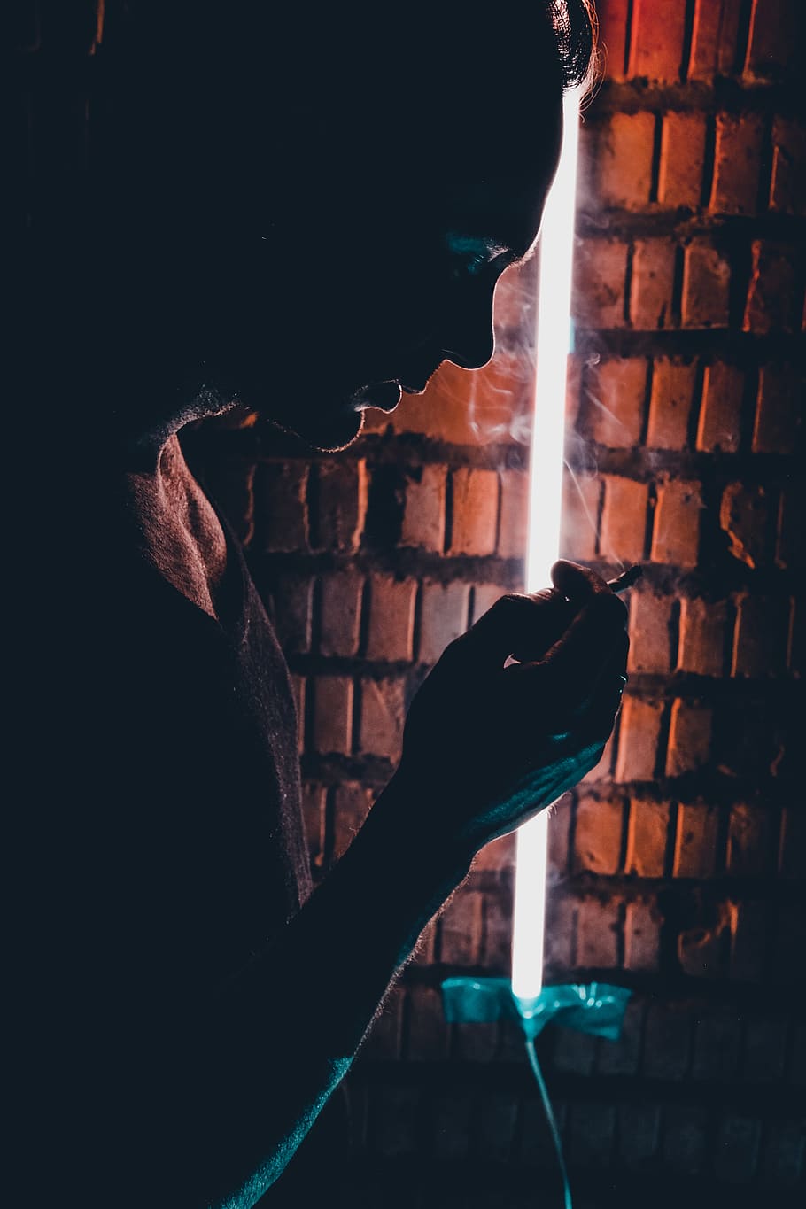 man about to smoke inside brown room, brick, person, human, people HD wallpaper