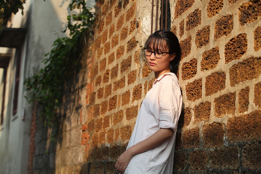 Woman Leaning on Brown Brick Wall, beautiful, bricks, daylight HD wallpaper